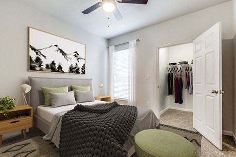 A bedroom with a large bed and a painting on the wall.
