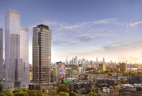 A cityscape with a mix of modern and older buildings under a clear sky.