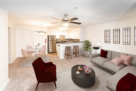 A living room with a red chair and a grey couch.