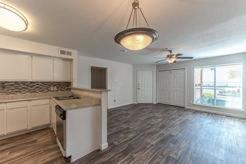A kitchen with a counter and a fan.
