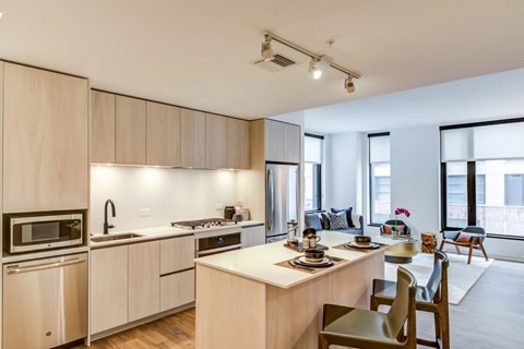 A modern kitchen with a dining table and chairs.