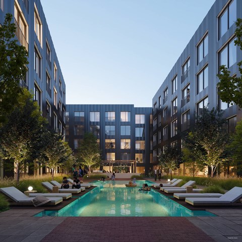 A swimming pool surrounded by lounge chairs in a courtyard.