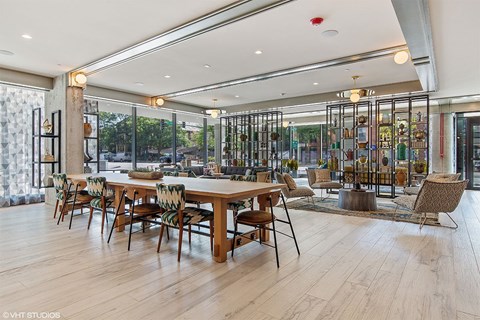 A dining room with a long table and chairs.