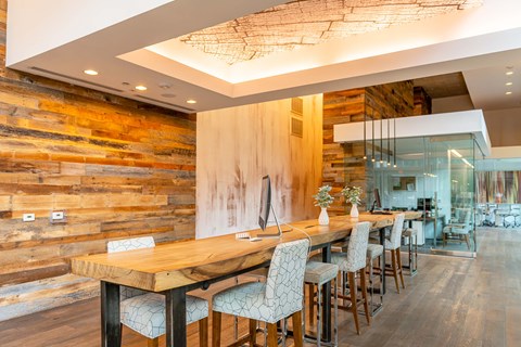 A modern dining room with a wooden table and chairs.