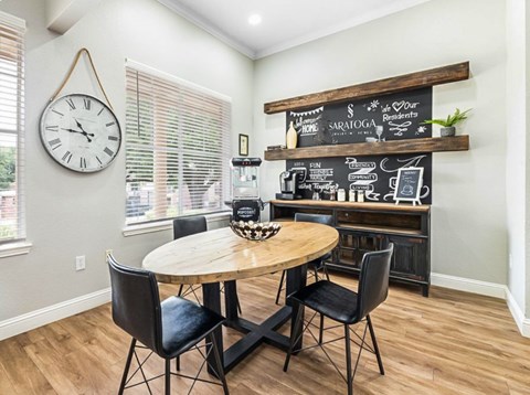 A dining room with a wooden table and chairs.