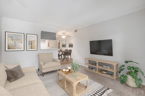 A living room with a couch, chair, and a television.