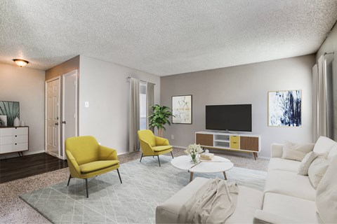 A living room with a yellow chair and a white couch.