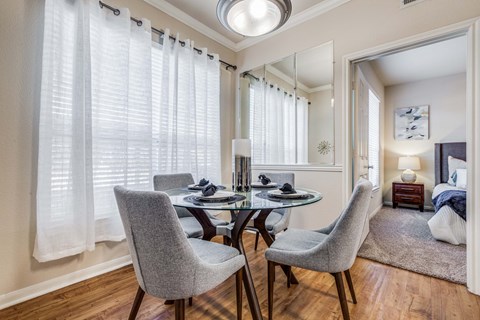 A dining room with a table and chairs.