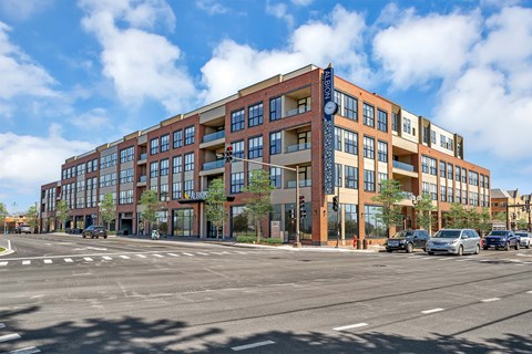 A large multi-story building with a blue and red sign on the side.