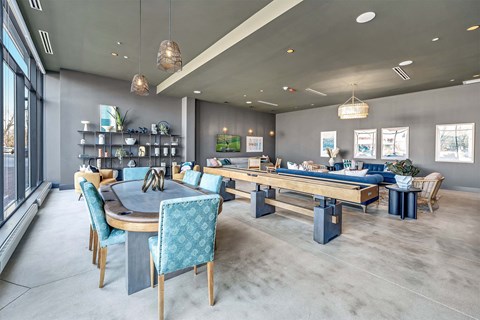 A modern dining room with a large table and chairs.