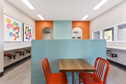 A dining area with a table and chairs.