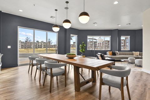A modern dining room with a large table and chairs.