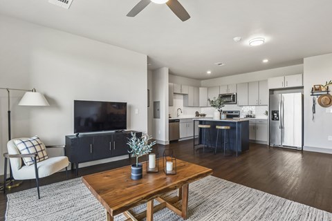 A modern living room with a wooden coffee table and a flat screen TV.