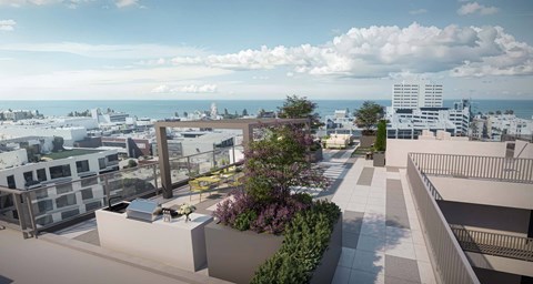 A modern building with a rooftop garden overlooks a cityscape.