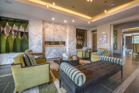 A living room with a black and yellow sofa and a green chair.