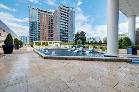 A pool area with a modern building in the background.
