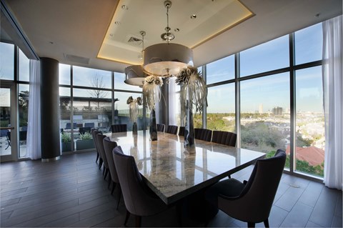 A modern dining room with a large table and chairs.