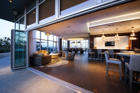 A modern living room with a dining area and a view of the outdoors.