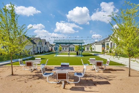 A park with a playground and benches.