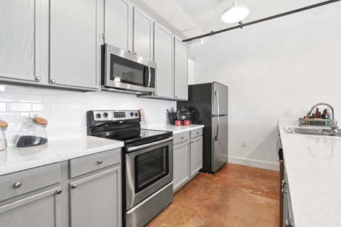 A kitchen with a black refrigerator and stove.
