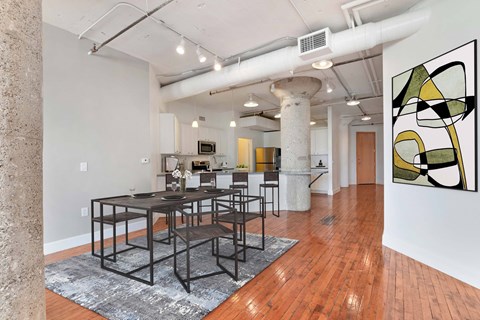A modern dining room with a large table and chairs.