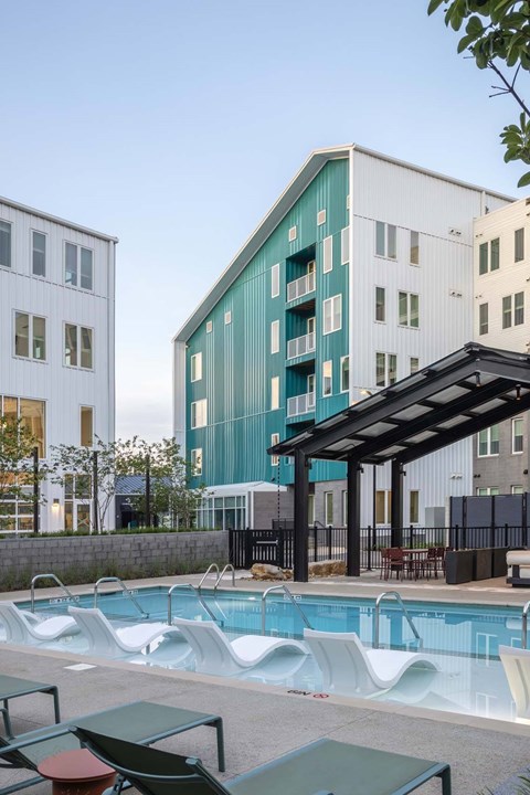 A modern building with a pool in front.