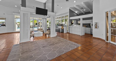 A modern living room with a stone floor and a television mounted on the wall.