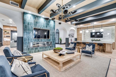 A modern living room with a glass backed television and a fireplace.