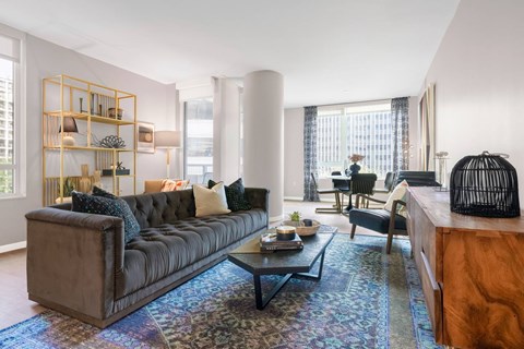 A living room with a brown sofa and a coffee table.