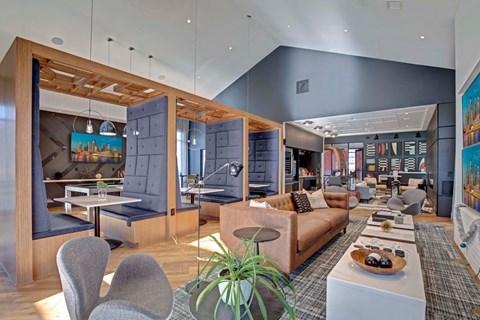 A modern living room with a grey sofa and a wooden table.