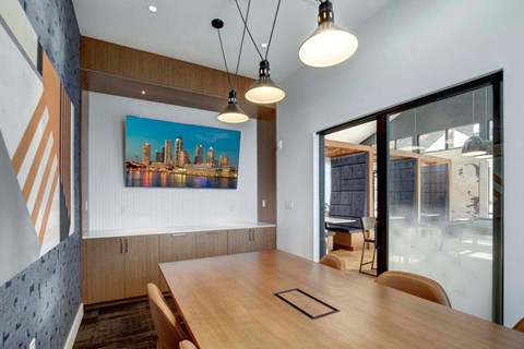 A modern dining room with a wooden table and chairs.