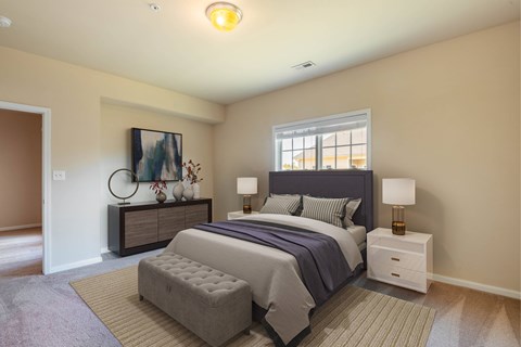 A bedroom with a large bed and a painting on the wall.