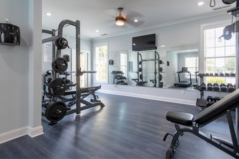 A spacious home gym with a variety of exercise equipment.