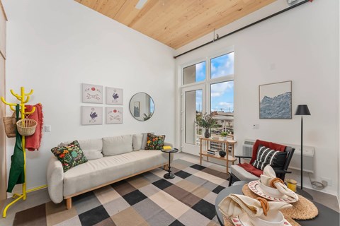 A living room with a white couch and a checkered floor.