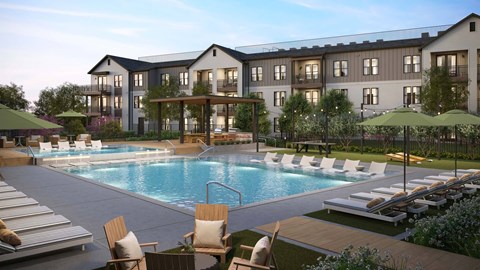 A large building with a pool in front of it.