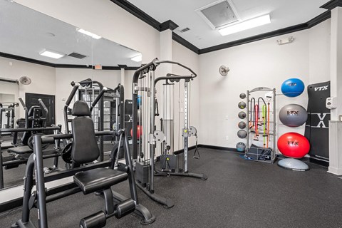 A gym with a variety of equipment including weights and resistance bands.