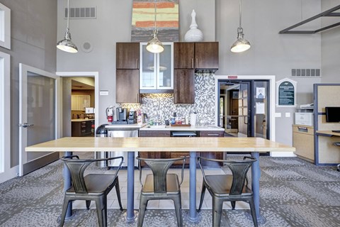 A kitchen with a table and chairs in the middle of the room.