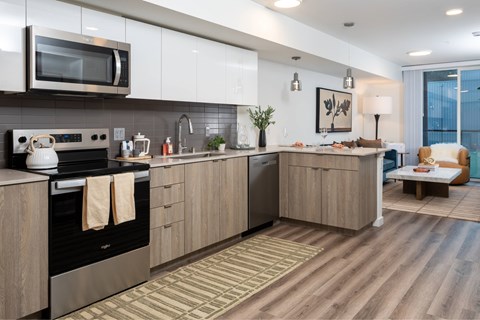 A modern kitchen with wooden cabinets and stainless steel appliances.