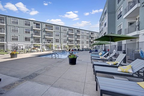 A sunny day at the outdoor pool area of a residential building.