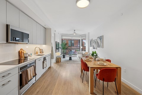 A kitchen with a table and chairs in the middle of the room.