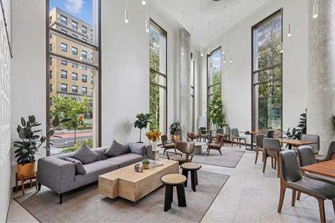 A living room with a grey couch and wooden coffee table.