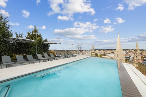 A large swimming pool with a view of the city.