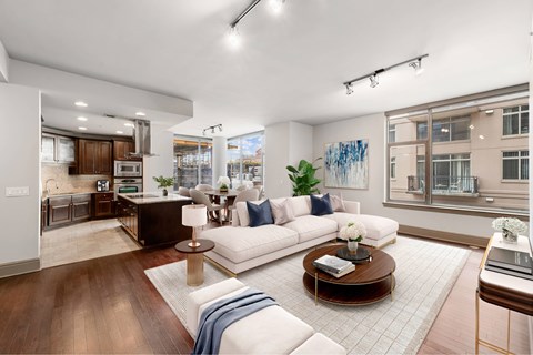 A modern living room with a white sofa and a coffee table.
