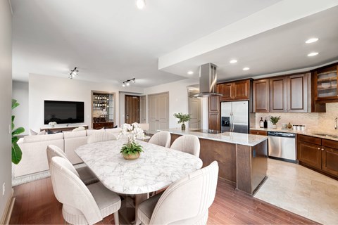 A modern kitchen with a dining table and chairs.