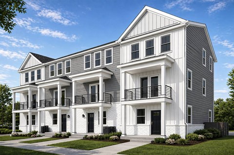 A modern two-story house with a balcony on the second floor.