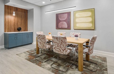 A dining room with a wooden table and chairs.