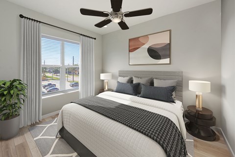 A bedroom with a large bed and a ceiling fan.