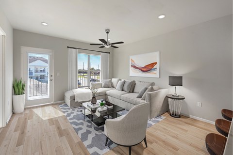 A living room with a white couch, a grey armchair, a coffee table, and a painting on the wall.