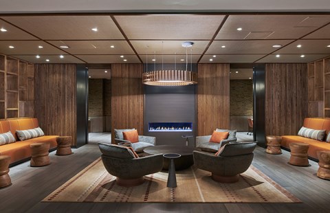 A modern living room with a large wooden table and sofas.