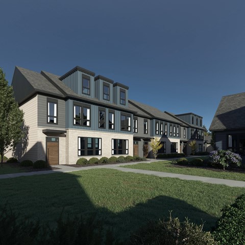 A modern house with a grey roof and white walls.
